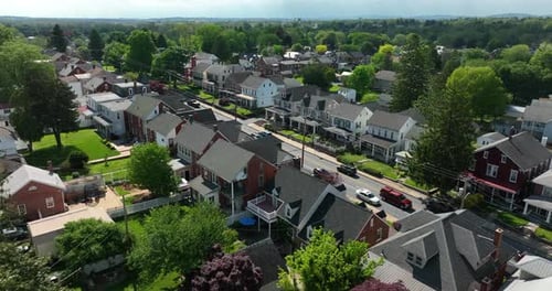 Aerial approach towards town houses. Small town America in spring. Colorful day in Pennsylvania.