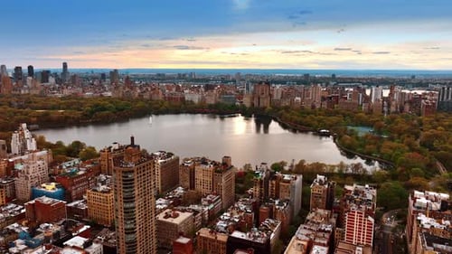 Approaching the big pond surrounded by colorful autumn trees in Central Park, New York.