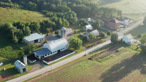 Rural agriculture community town in America. USA aerial with farm barns and homes.