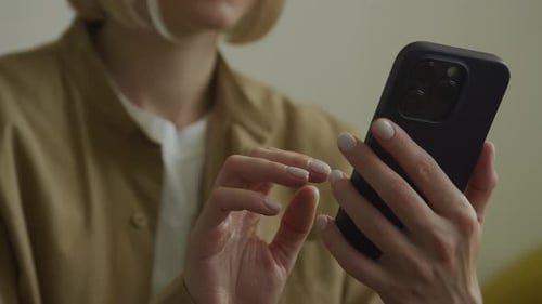 Woman Using Smartphone in Soft Indoor Light