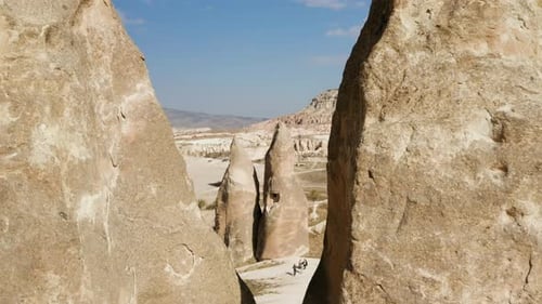 Cappadocia Fairy Chimneys, Hoodoo Rock Formation On A Sunny Day In Turkey. - aerial pullback