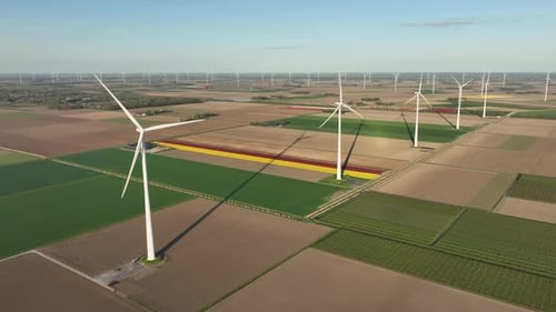 Fields and wind turbines. A wind generator on the field. View from drone.