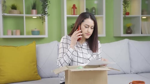 Woman on Phone with Box at Home