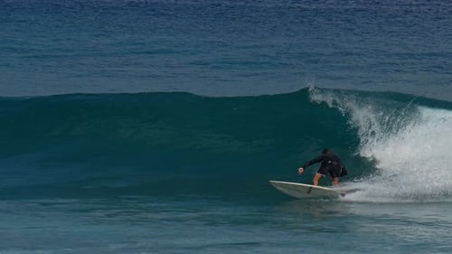 Young Guy Surfs in the Ocean