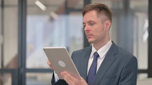 Man Using Tablet in Modern Corporate Office