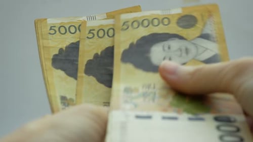 Counting Korean Won Currency Banknotes Close Up