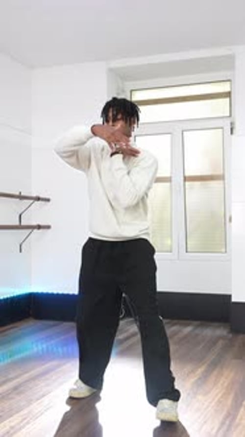 Young Man Dancing in Studio with Natural Light