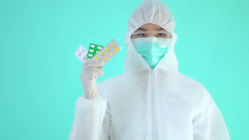 Healthcare worker holding blister packs of medication