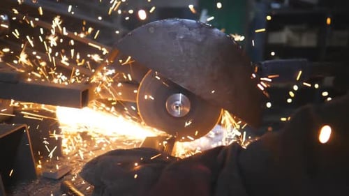 Metalworker Cutting Steel with Sparks Flying
