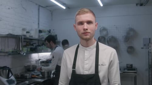 Young Chef Standing in Professional Kitchen