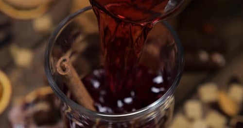 Pouring Spiced Mulled Wine with Festive Holiday Flavors