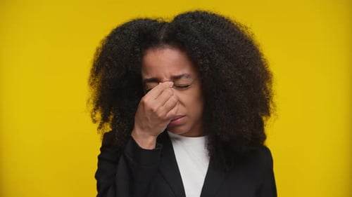 Young Adult Woman Holding Hand To Face