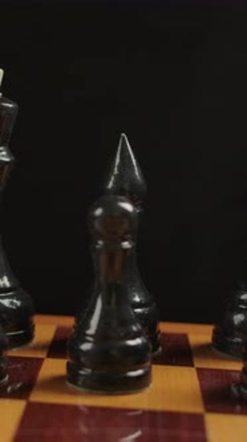Close Up of Black Chess Pieces on Board