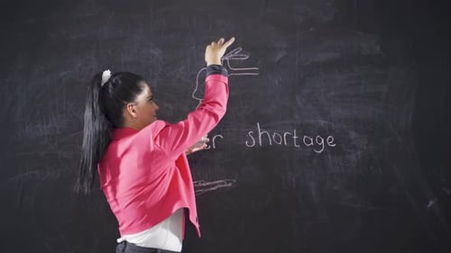 Woman writing water outage on blackboard looks at camera with empty glass.