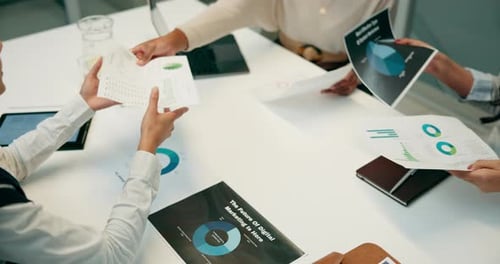 Corporate Team Meeting Analyzing Data at Table