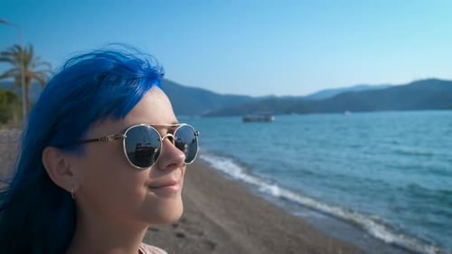 A Young Girl with Blue Hair By the Blue Sea
