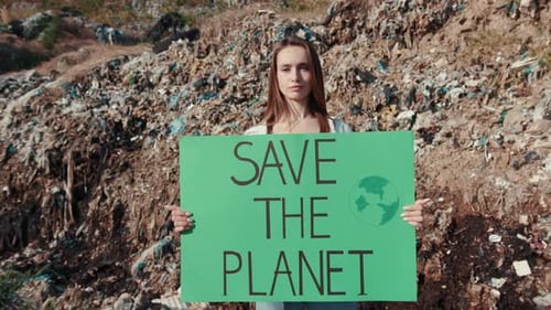 Young Adult Holding 'Save The Planet' Sign