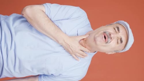 Mature Adult with Painful Sore Throat on Orange