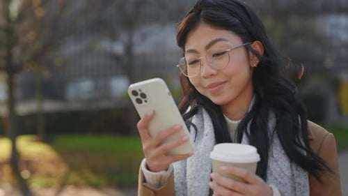 Woman Using Smartphone in Urban Environment