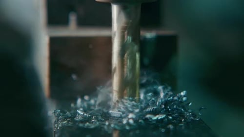 Rapid Metal Cutting Cnc Operator Observes Highspeed Tool Operation and Debris Dispersion Closely