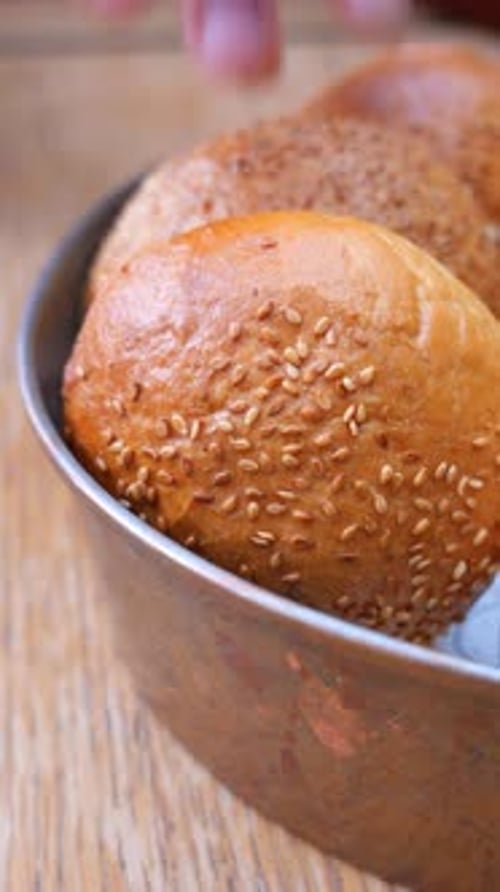 Woman Hand Pick Baked Bun on Table