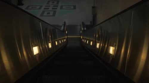 Going down a dark escalator at a subway station
