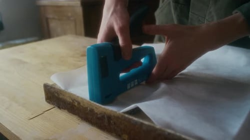 Close Up of Hands Using Staple Gun