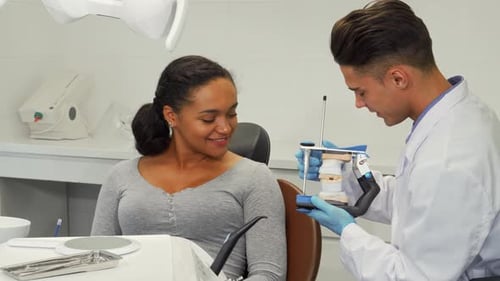 Dentist Explains Dentures to Smiling Patient
