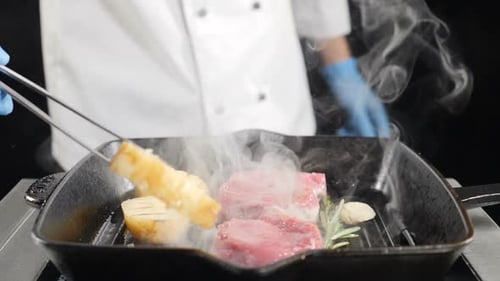 Chef Cooking Potato with Meat on Grill