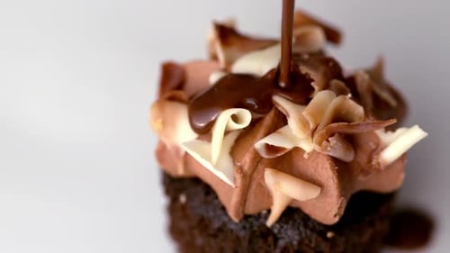 Chocolate Sauce Pouring Over Muffin