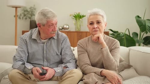 Senior Couple Relaxing on Couch in Living Room