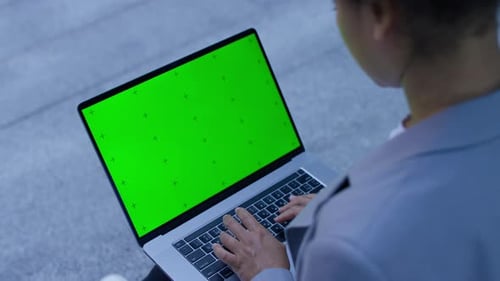 Businesswoman Typing on Laptop with Green Screen