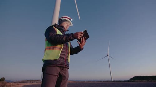 Engineer Using Digital Tablet at Wind Power Station