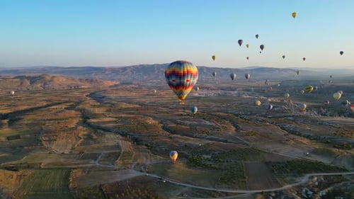 Hot Air Balloons Floating Over Valley at Sunrise