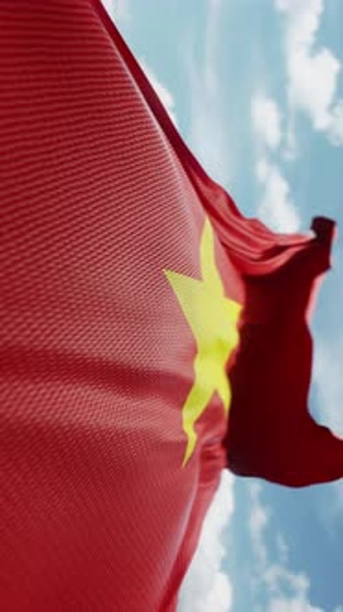 National Flag of Vietnam Waving Against Blue Sky