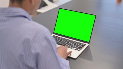 African Woman Working on Laptop with Green Screen