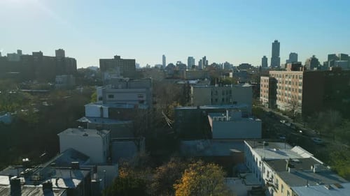 Forwards Fly Above Buildings in Residential Urban Borough at Golden Hour
