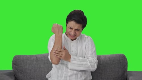 Sick Indian man applying a bandage Green screen
