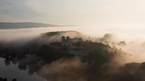 Aerial drone view of Benedictine Abbey over Vistula river in Tyniec in the morning fog, Krakow, Pola