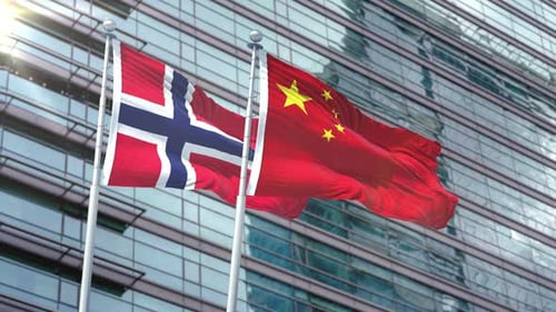 Flags of Norway and China Waving on Modern Business Building