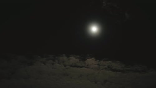 Moonlight Illuminates Clouds in the Night Sky