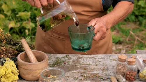 Adult Preparing Herbal Tea Outdoors