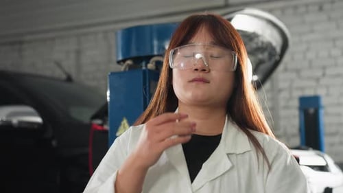 Inventor Adjusting Protective Glasses in Automotive Workshop with Machinery