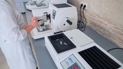 Laboratory Worker Prepares Tissue Samples with Microtome