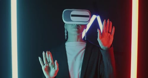 Young Adult Wearing VR Headset in Neon Setting