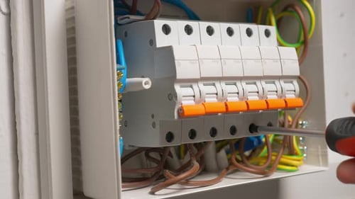 Electrician Assembles Electrical Panel