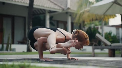Woman Doing Yoga in a Tropical Villa Backyard