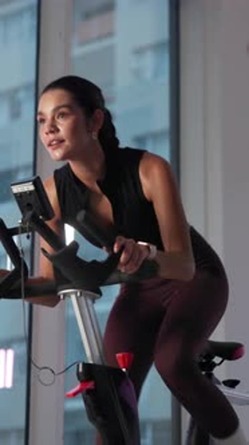 Sweat, spin class and woman on bike in gym for exercise, cardio workout and cycling for wellness