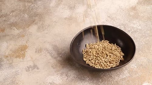 Grains Being Poured into a Bowl