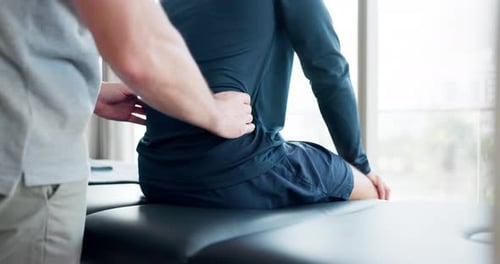 Medical Exam with Doctor Treating Patient's Back